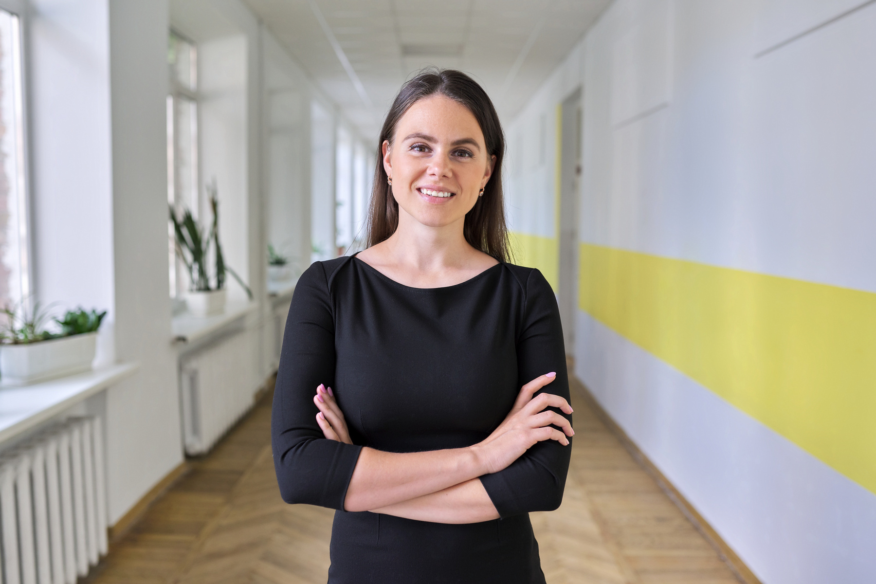 Portrait of young female teacher, social worker, psychologist at school