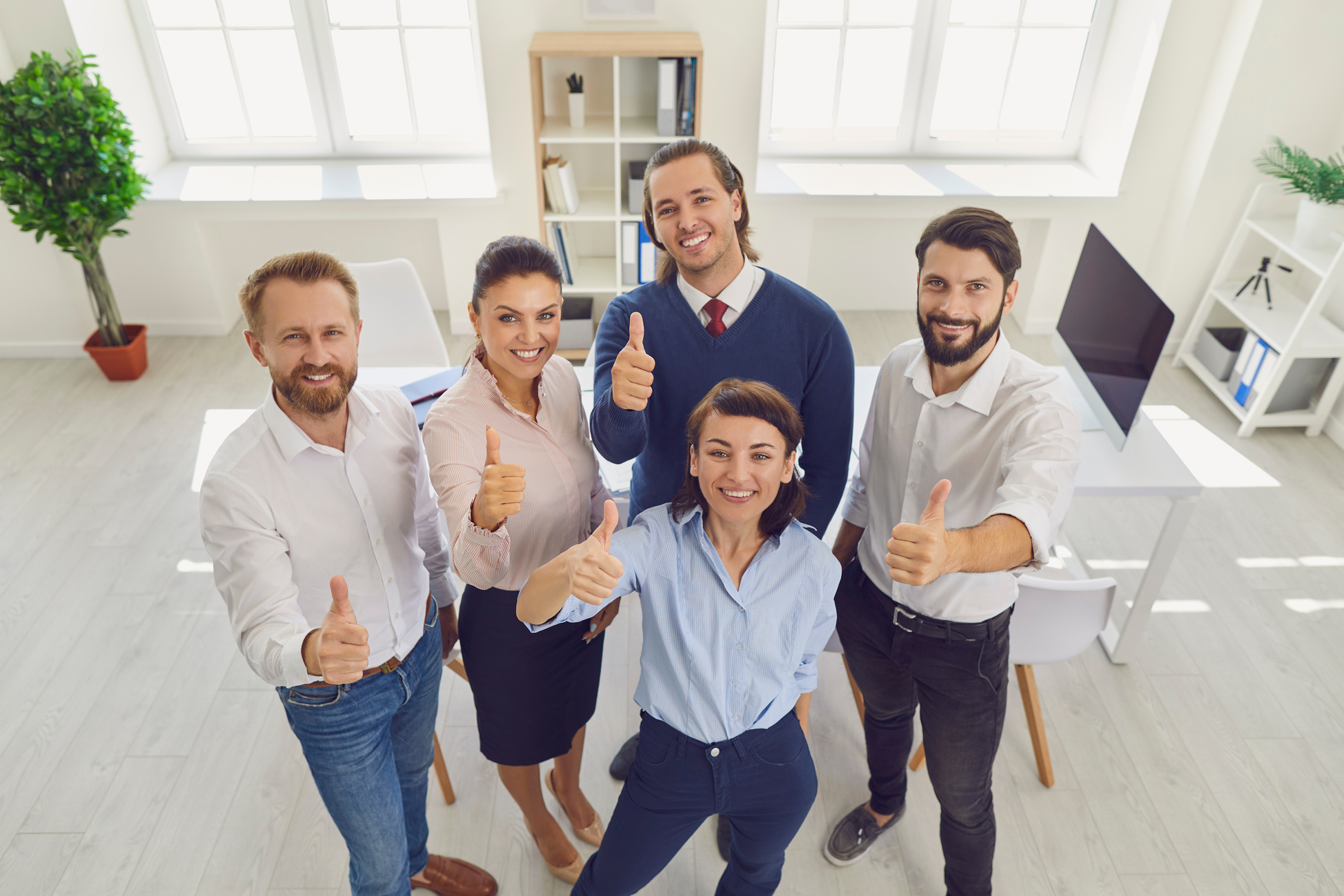 Group of Five Cheerful Office Workers Giving Thumbs-up Proud of Their Work Results