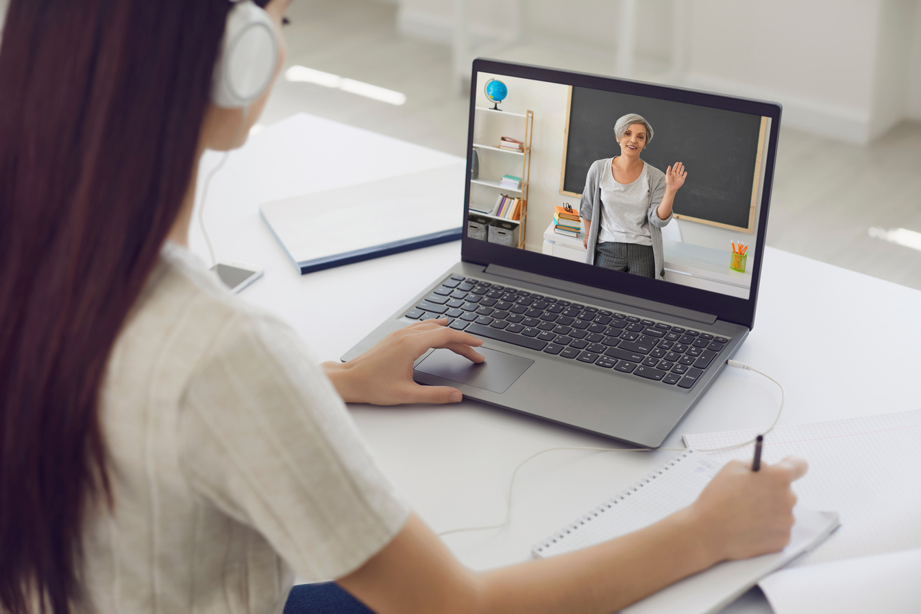 Female Student in Headphones Having Online Class